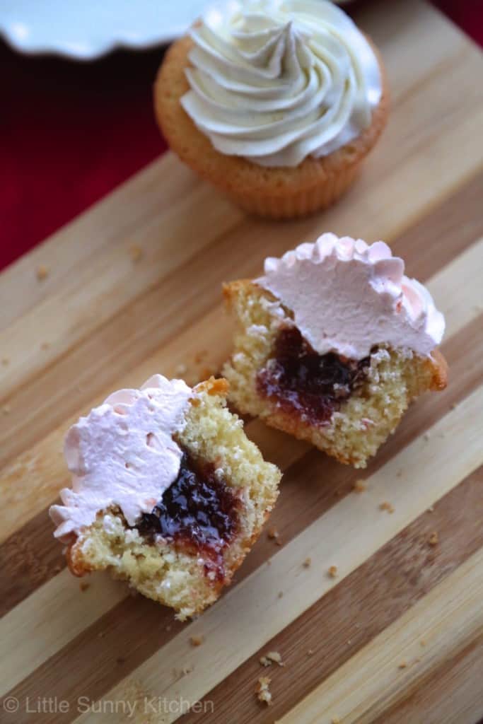 Jam filled cupcakes frosted with silky vanilla frosting